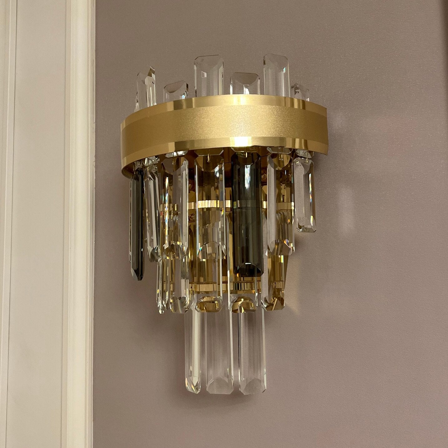 Close-up of the Brighouse Wall Light showcasing alternating rounded rectangle crystal prisms and warm illumination.