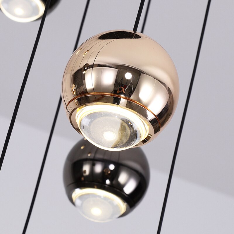 Detailed close-up of the Carlito chandelier’s polished metallic spheres and refined pendant craftsmanship.