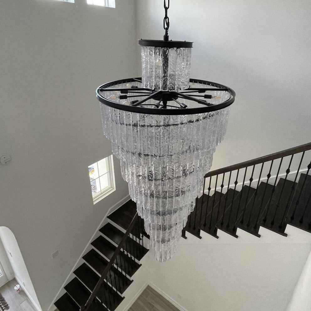 Luxury crystal staircase chandelier installed above a contemporary stair landing