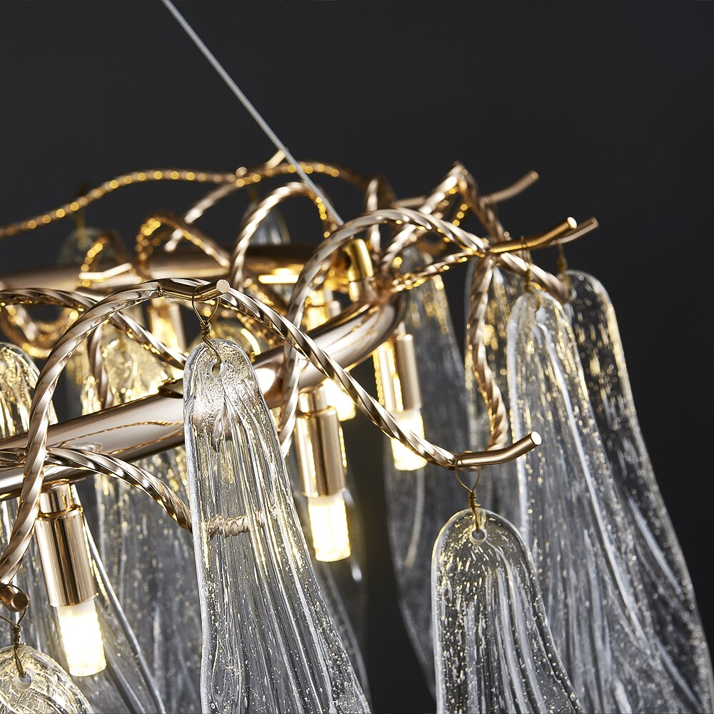 Close-up of Larvotto circular chandelier showing leaf-shaped glass and sculptural branch frame