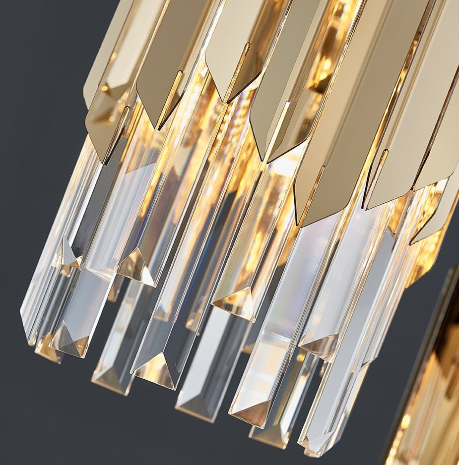 Detail of illuminated crystal bars on the VORELLI Manhattan Pendant Staircase Chandelier creating warm reflective light