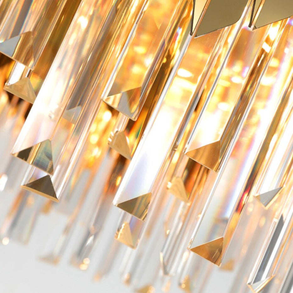 Detailed view of illuminated crystal bars on the VORELLI Manhattan Rectangular Chandelier creating warm reflections