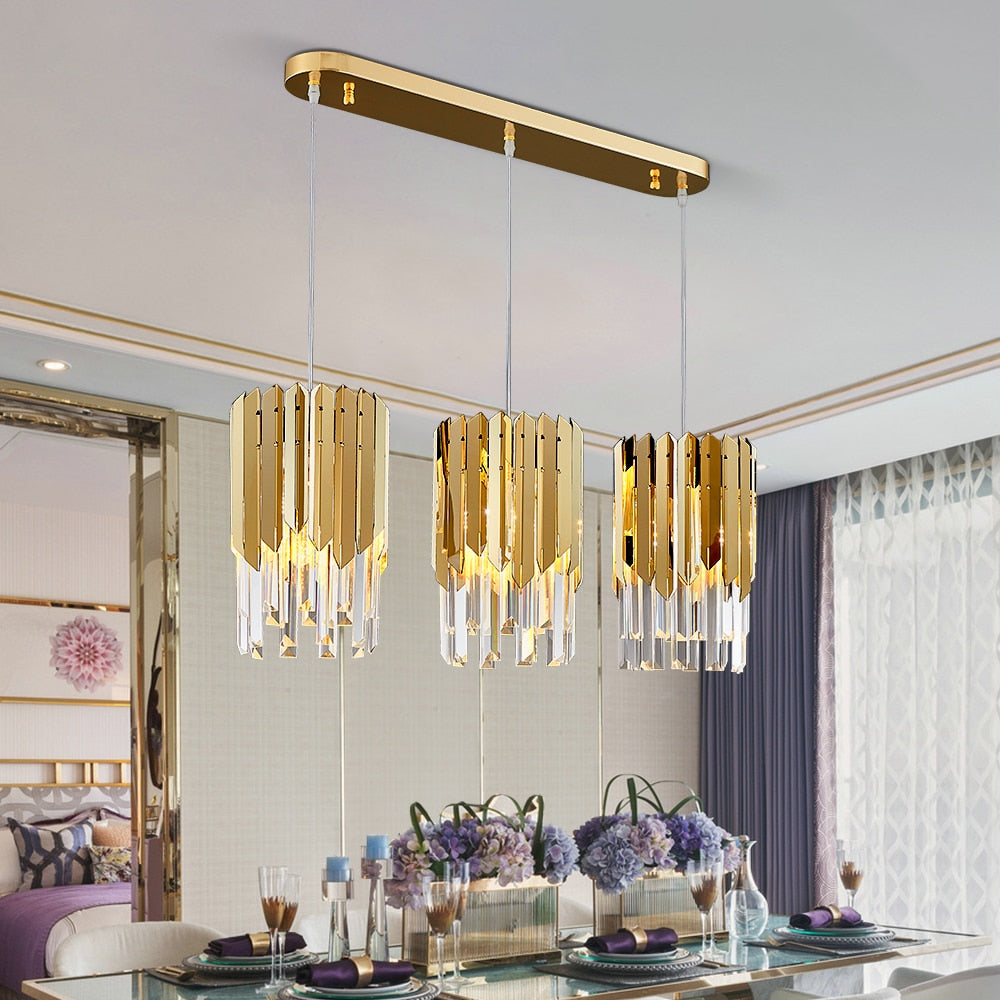 VORELLI Manhattan Rectangular Chandelier II with three cascading crystal pendant lights above a luxury dining table