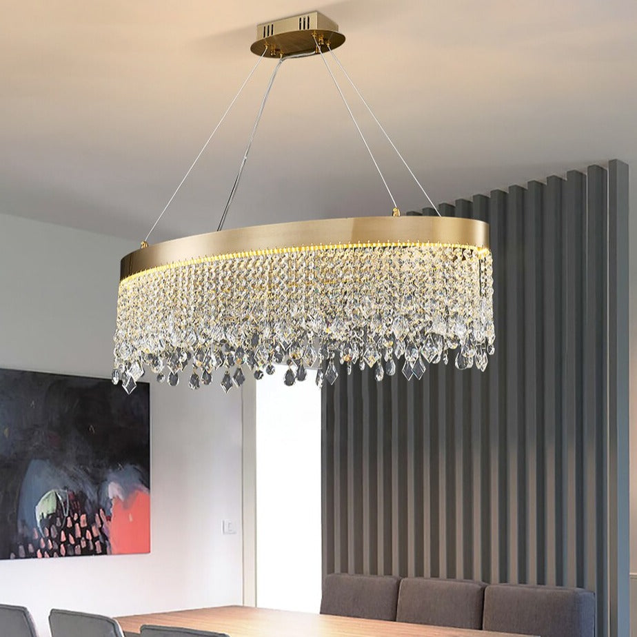 VORELLI® Modesto oval chandelier suspended above dining table with layered diamond cut crystal chains