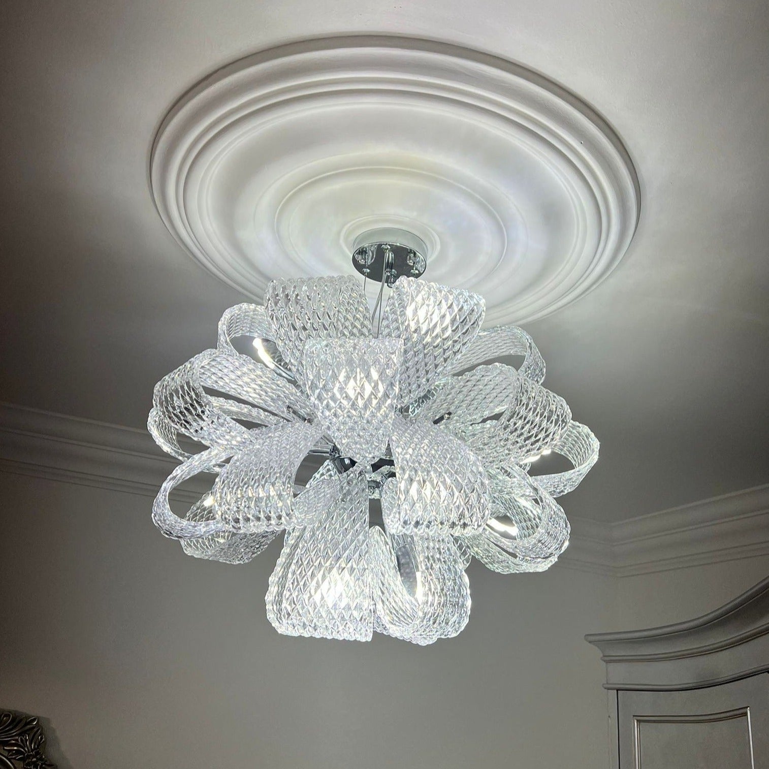 VORELLI® Munz modern glass chandelier installed on ceiling with flowing ribbon inspired glass structure
