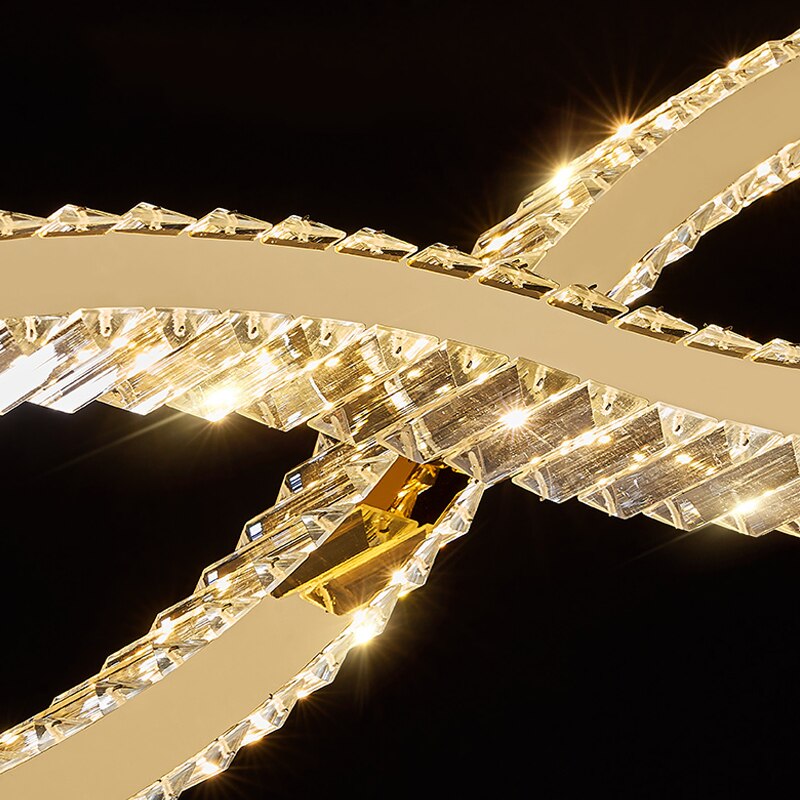 Detailed view of sculptural wave shaped frame on VORELLI® Oia rectangular crystal chandelier
