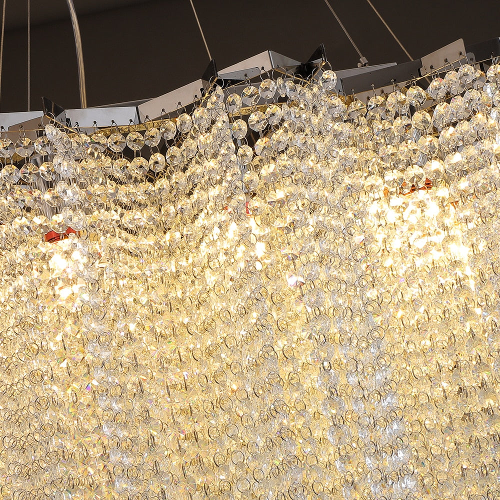 Luxury crystal chain stairwell chandelier by VORELLI® illuminating a sweeping staircase in a refined residential or hospitality setting