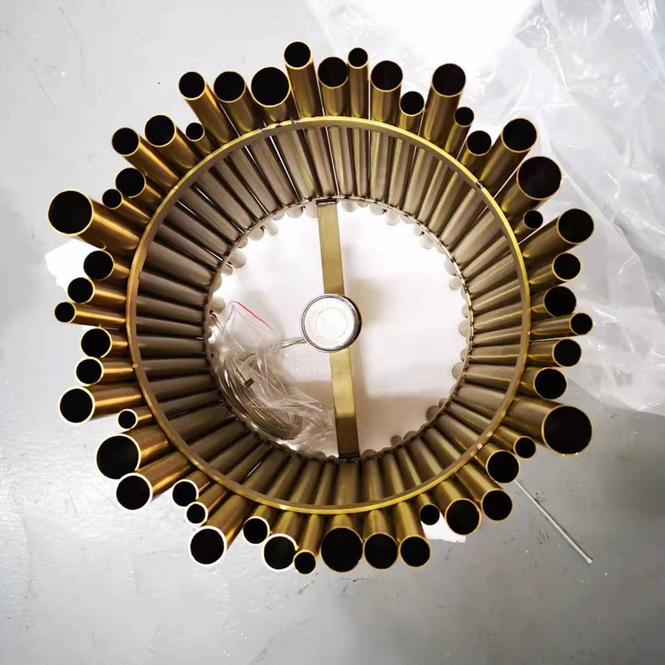 Bottom view of pendant light showing circular arrangement of cylindrical tubes for layered lighting effect