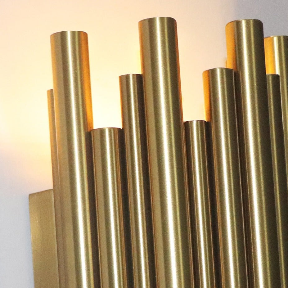 Close-up of vertical cylindrical tubes on modern wall light creating refined ambient lighting effect