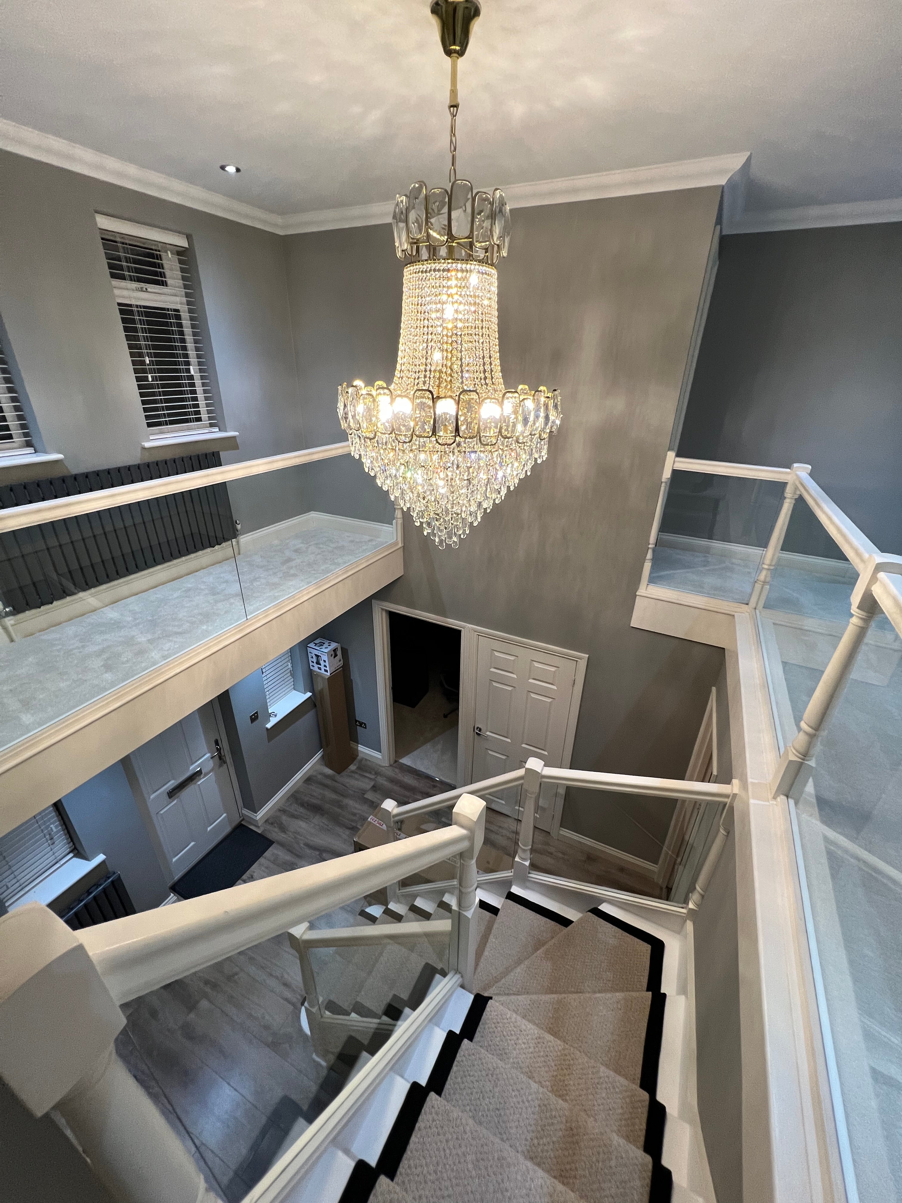 Grandeur luxury crystal staircase chandelier installed in a grand residential stairwell