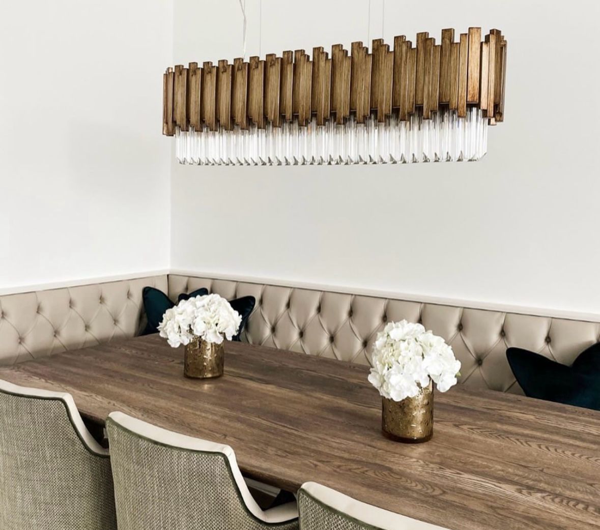 VORELLI® Zanero Series rectangular chandelier with wood-inspired detailing and elongated crystal prisms above a luxury dining table