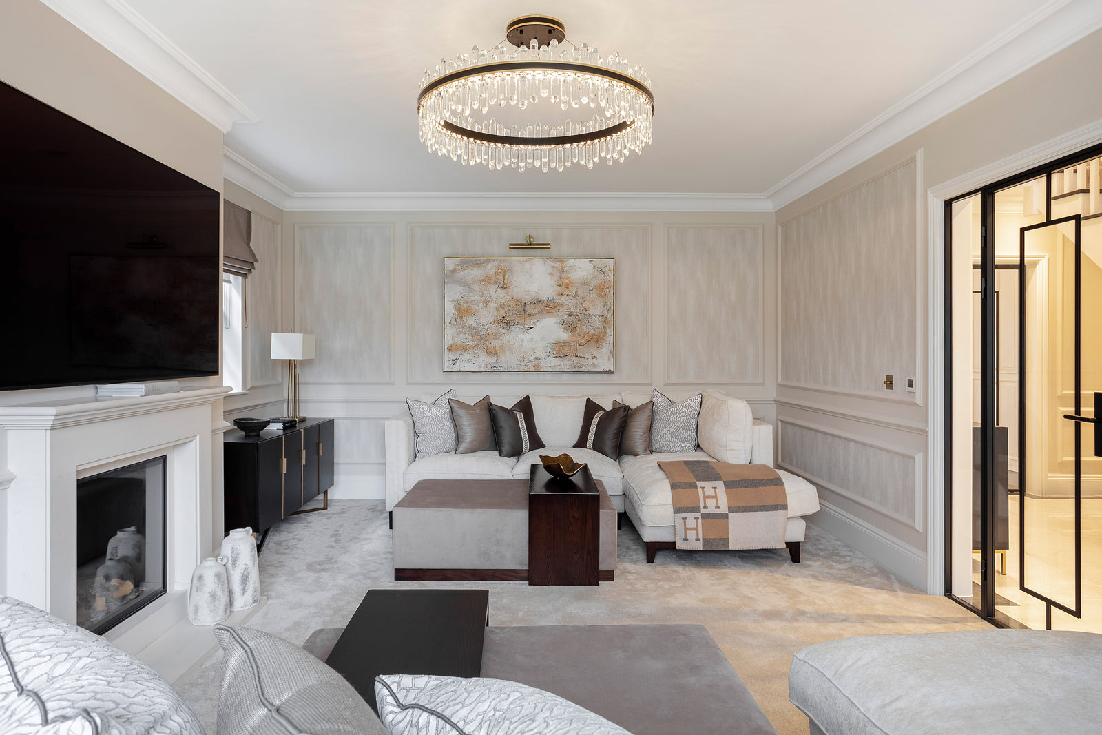 Luxury residential lighting scheme with VORELLI chandelier in a refined living room