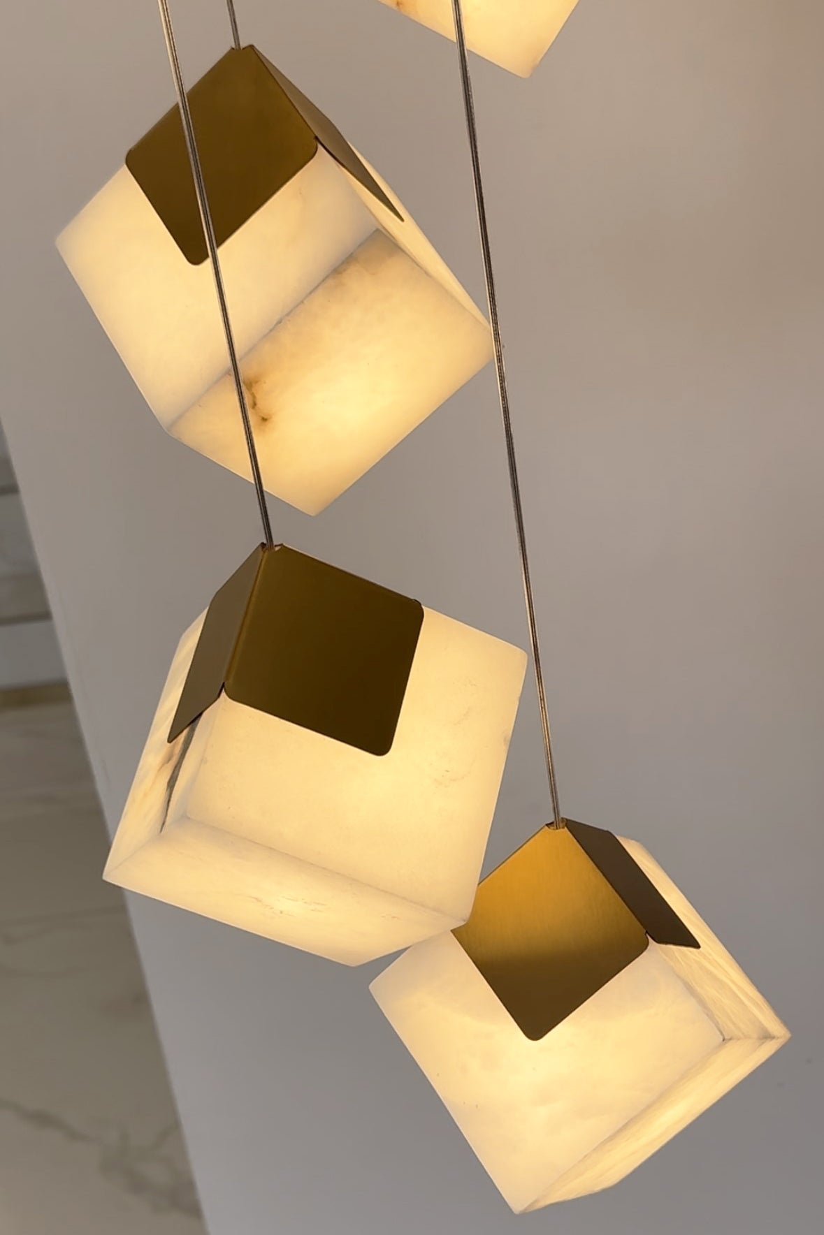 Cluster of Cube Alabaster Marble Pendants Hanging in a Modern Interior