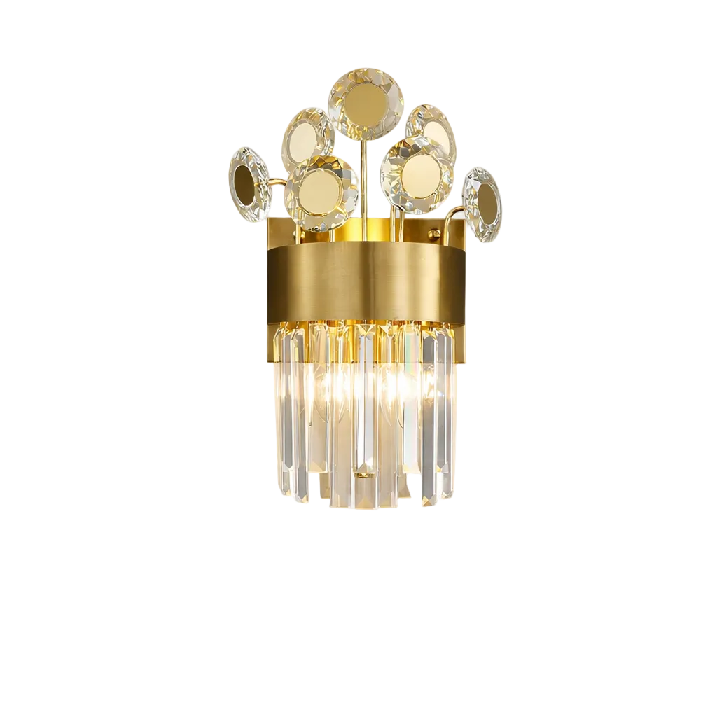 A close-up shot of the Patara Wall Light II by VORELLI, highlighting the intricate diamond cut crystal discs layered over polished stainless steel bands to create a luxurious, glowing ambience.