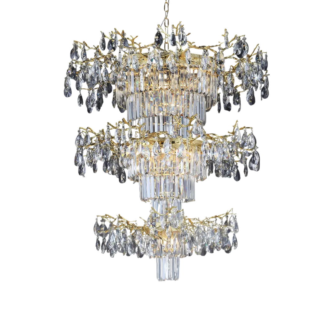 A dramatic, atmospheric view of the VORELLI Dewdrop Grandeur Staircase Chandelier II, capturing the opulent mood of cascading crystal drops glowing within a grand, high-ceilinged architectural space.