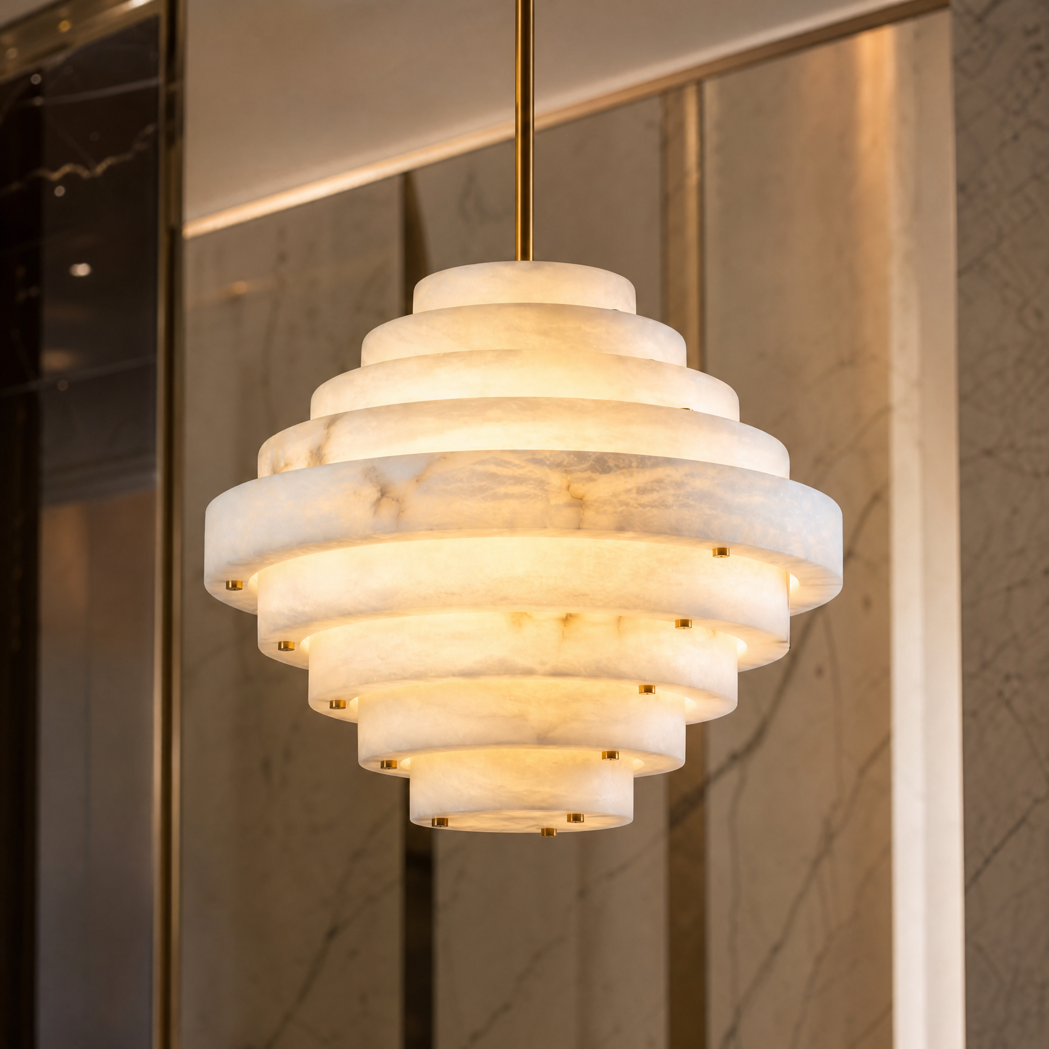 A dramatic view of the Beehive Circular Chandelier highlighting the distinct, vein-like patterns inherent to its natural Spanish alabaster discs.