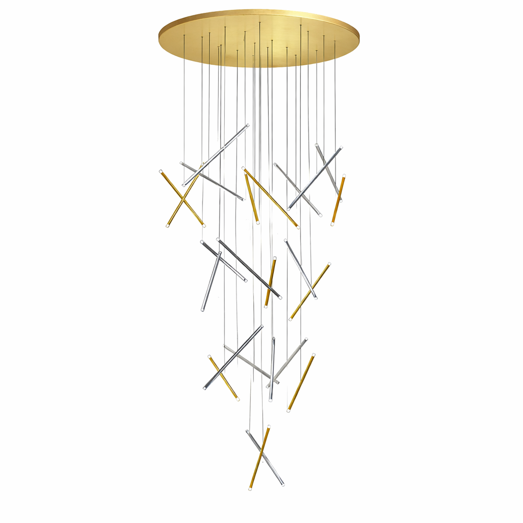 A striking vertical composition of the VORELLI Rizzano staircase chandelier casting soft, warm architectural illumination over a grand residential stairway.
