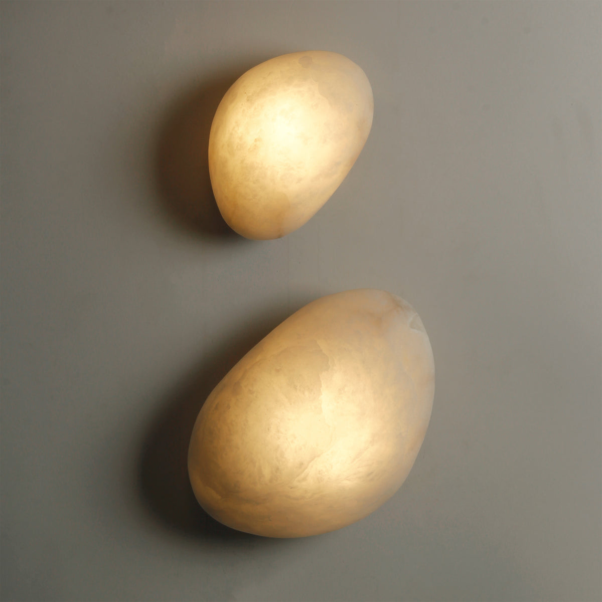Top-down view of two VORELLI® Alba Wall Lights showcasing varied marble forms and ambient texture