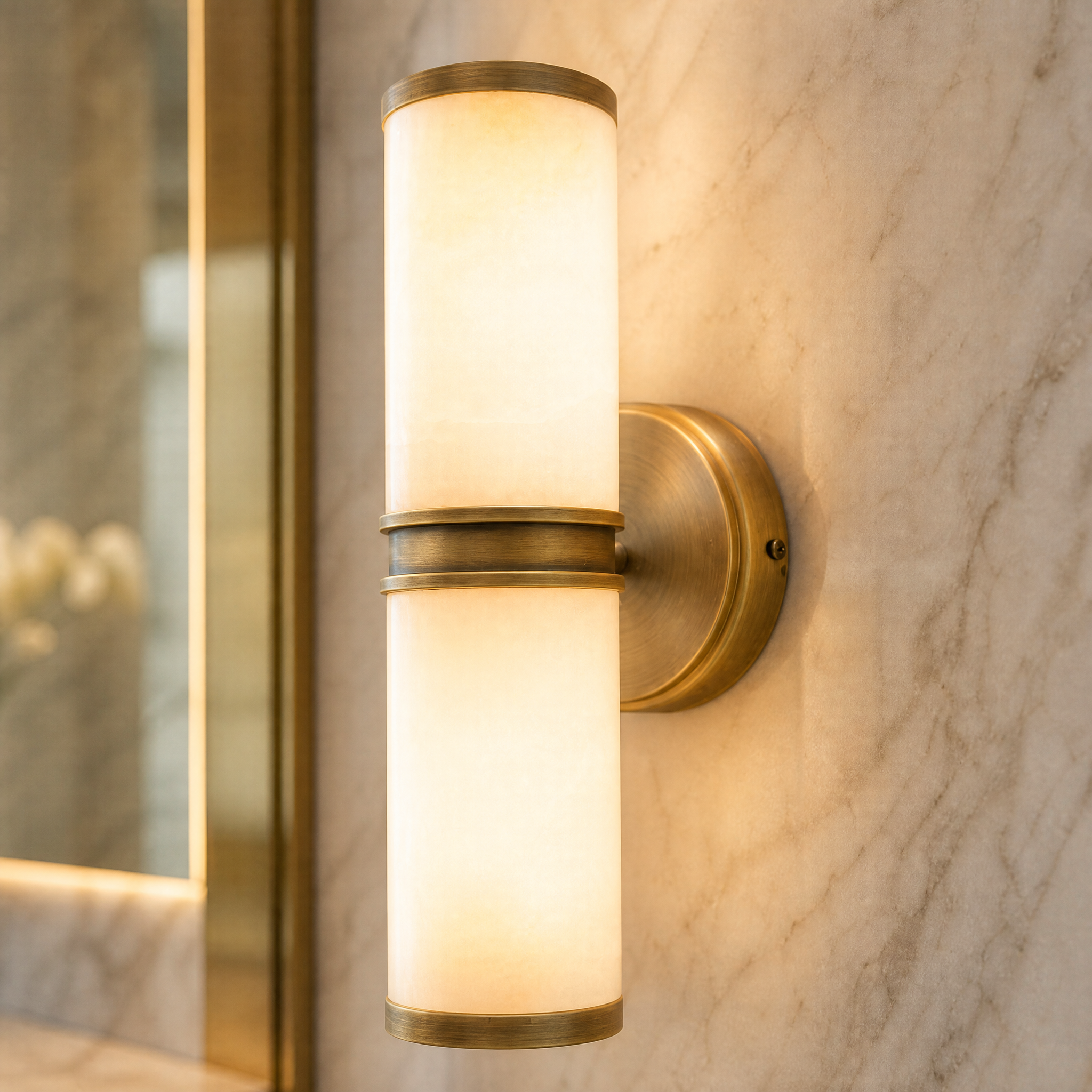 Macro closeup of the Almora Wall Light showing the intricate natural veining of the solid alabaster stone and the refined antique brass detailing.