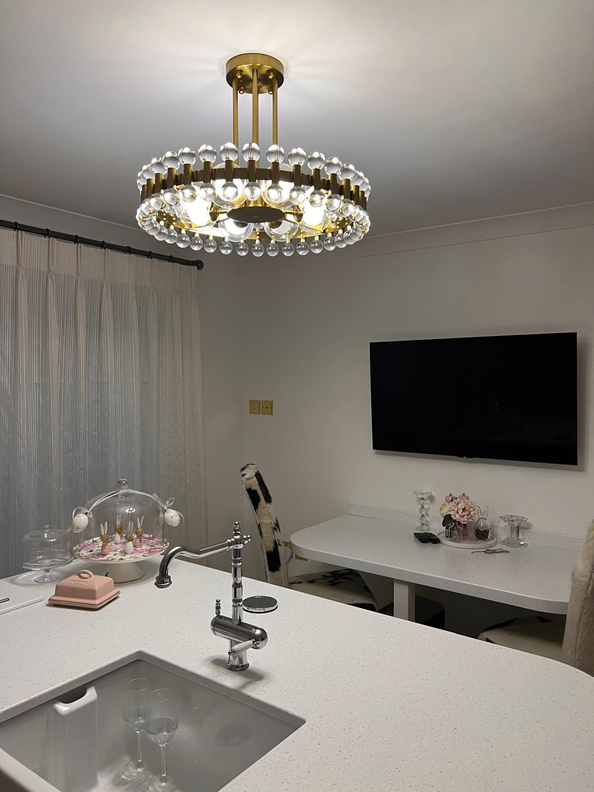 Illuminated Alytus pendant light highlighting refined crystal detailing