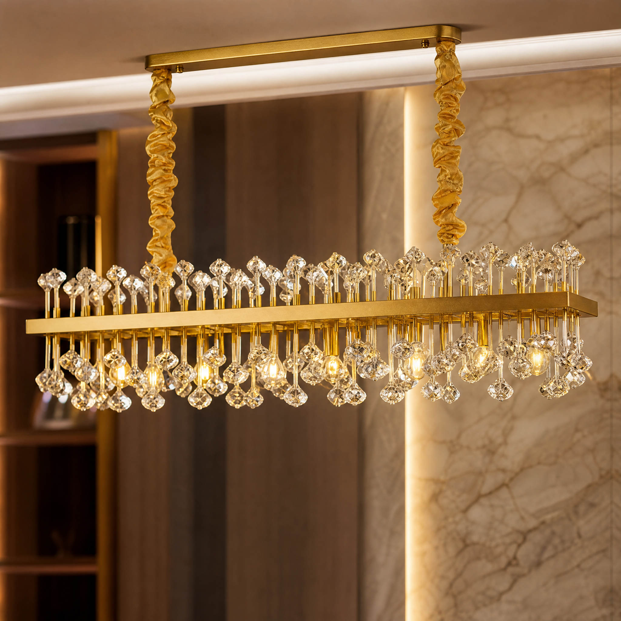Close-up detail of the playful crystal droplets and refined metal framework of the VORELLI Alytus rectangular chandelier.