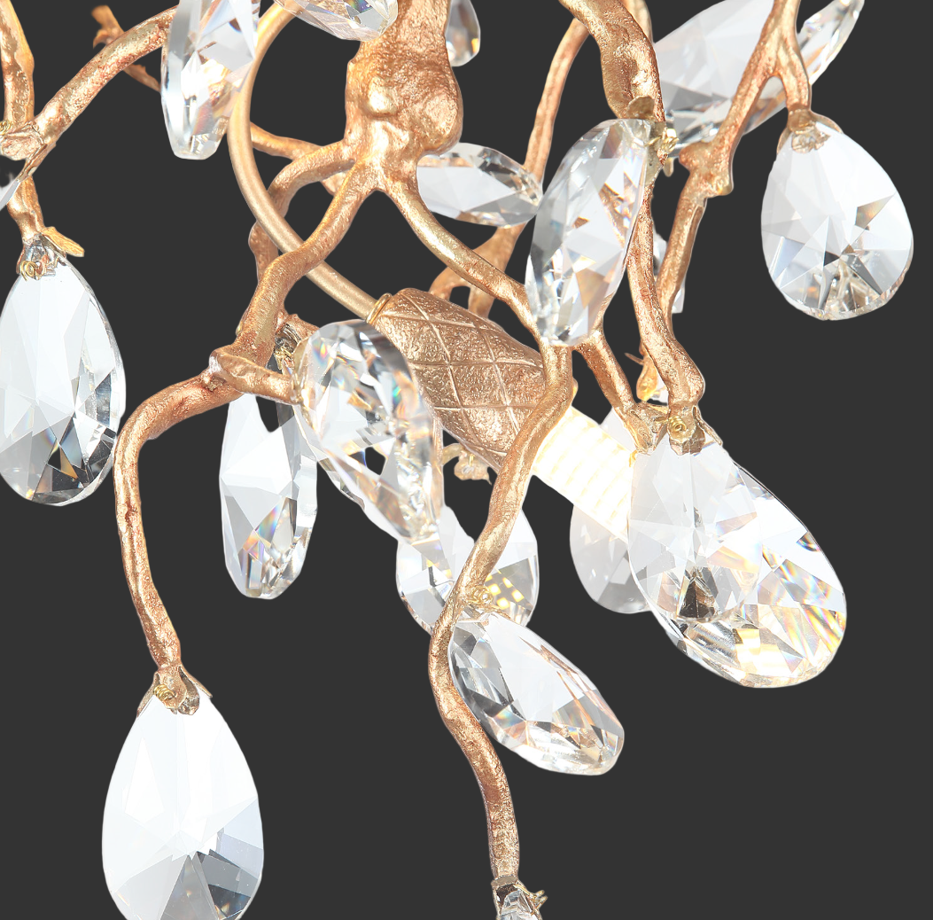 An atmospheric shot showcasing the sophisticated mood and flowing sculptural movement of the VORELLI Entwine crystal chandelier in an elevated contemporary space.