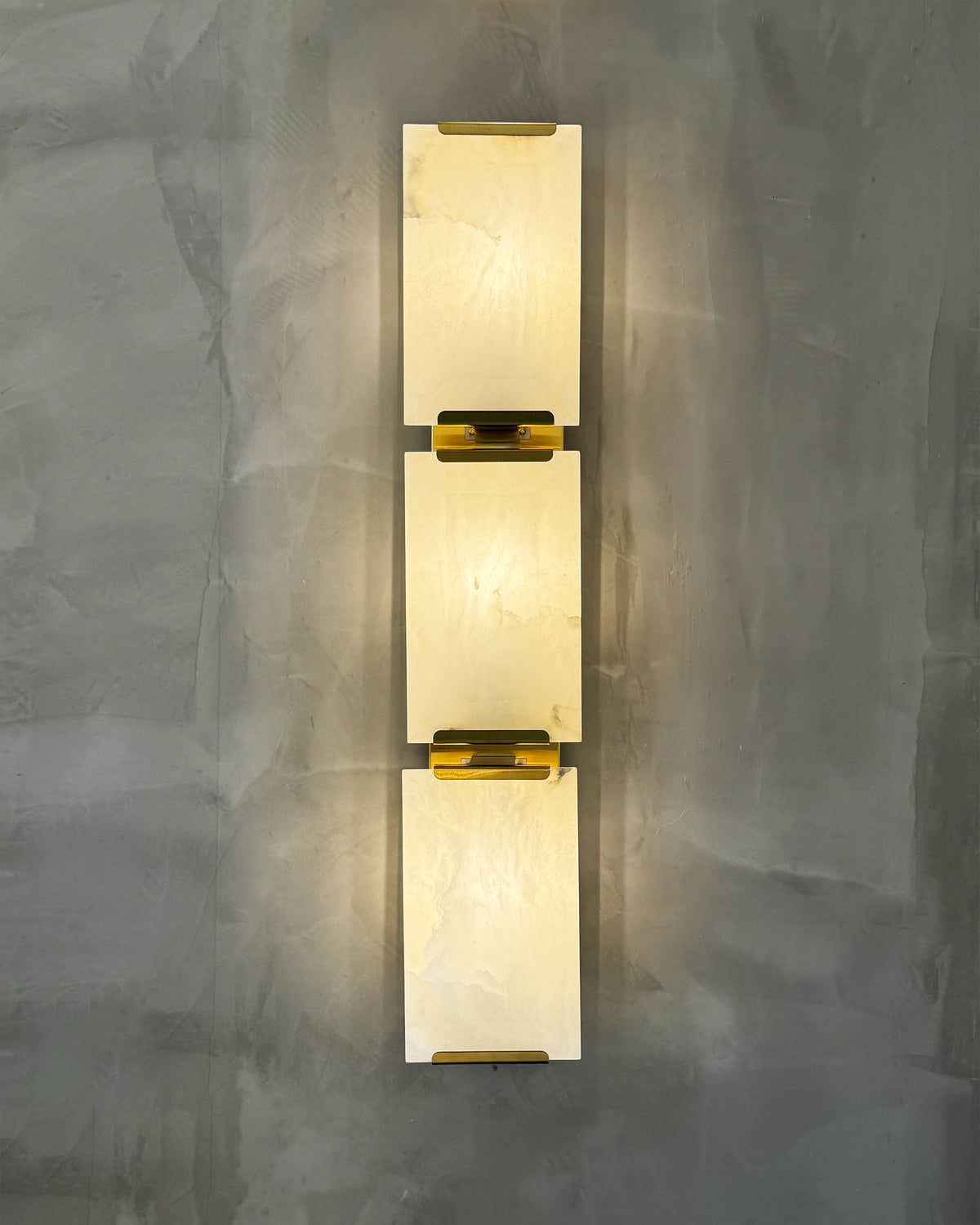 Close-up of the brass detailing on Angel Marble Wall Light II, showing its luxury craftsmanship.