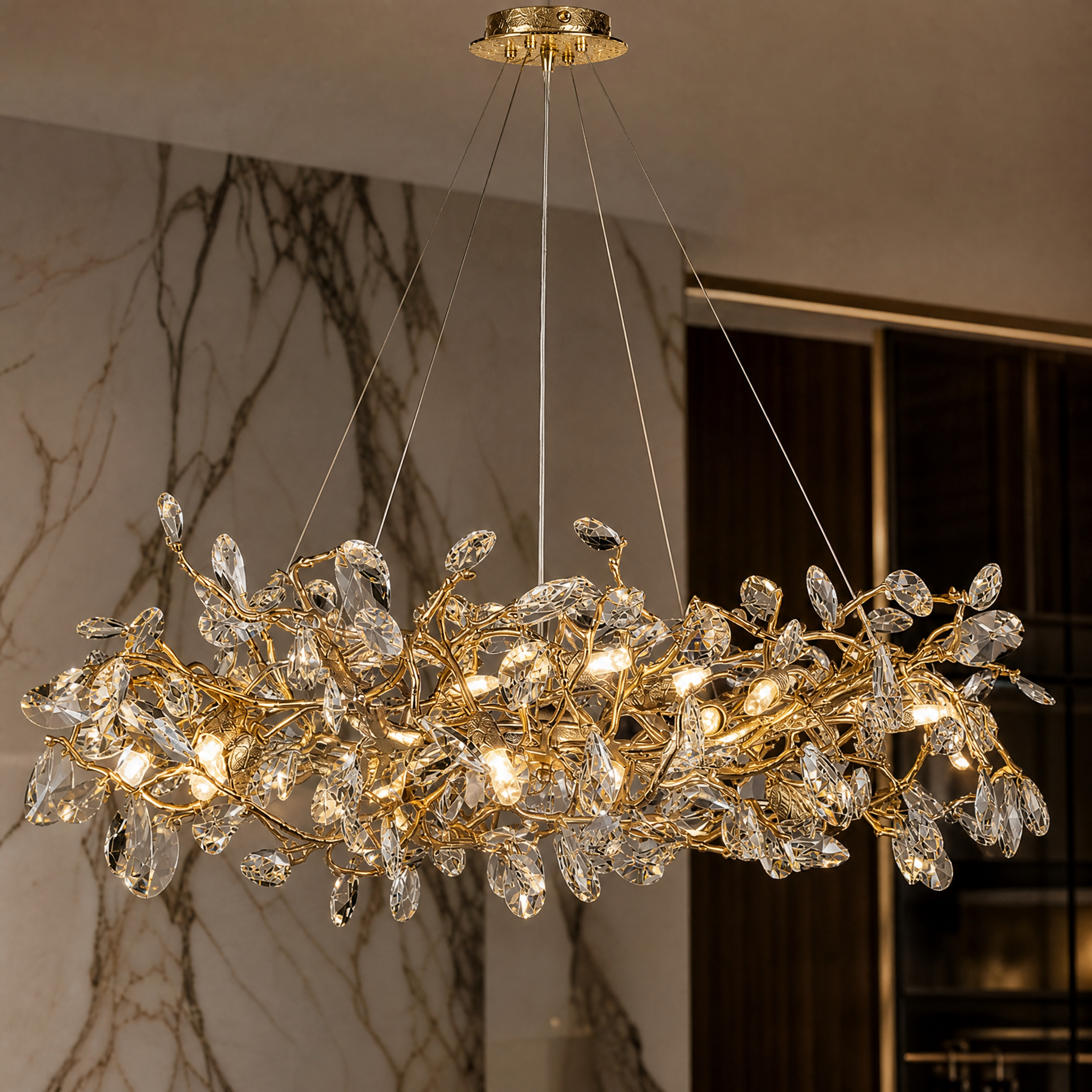 Macro detail view of the VORELLI Arboré chandelier showing faceted crystal drops on a sculptural branch-like metallic frame.