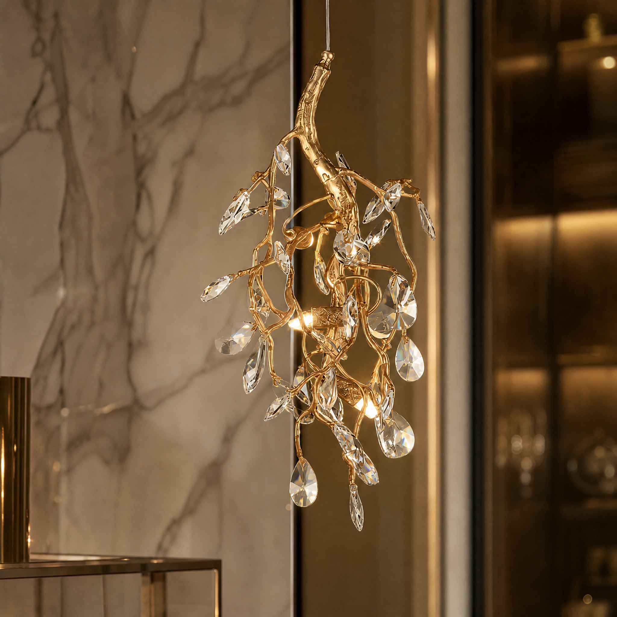 Close up of the Arboré Pendant Light showing faceted crystal drops on an intricate branch-like metal frame.
