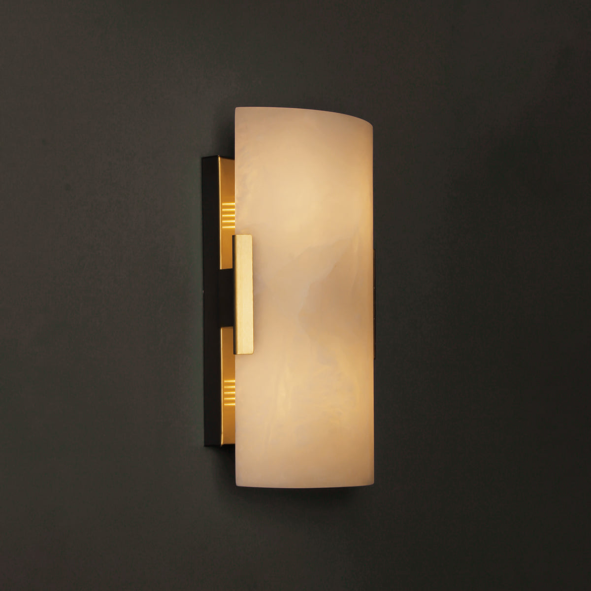 Side angle showcasing the black and gold detailing of the Arco marble wall light.