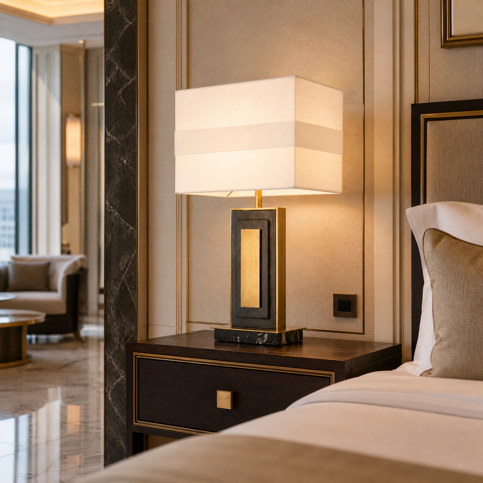 Sophisticated Ardelle table lamp with brass finish placed in a luxury hotel bedroom interior.