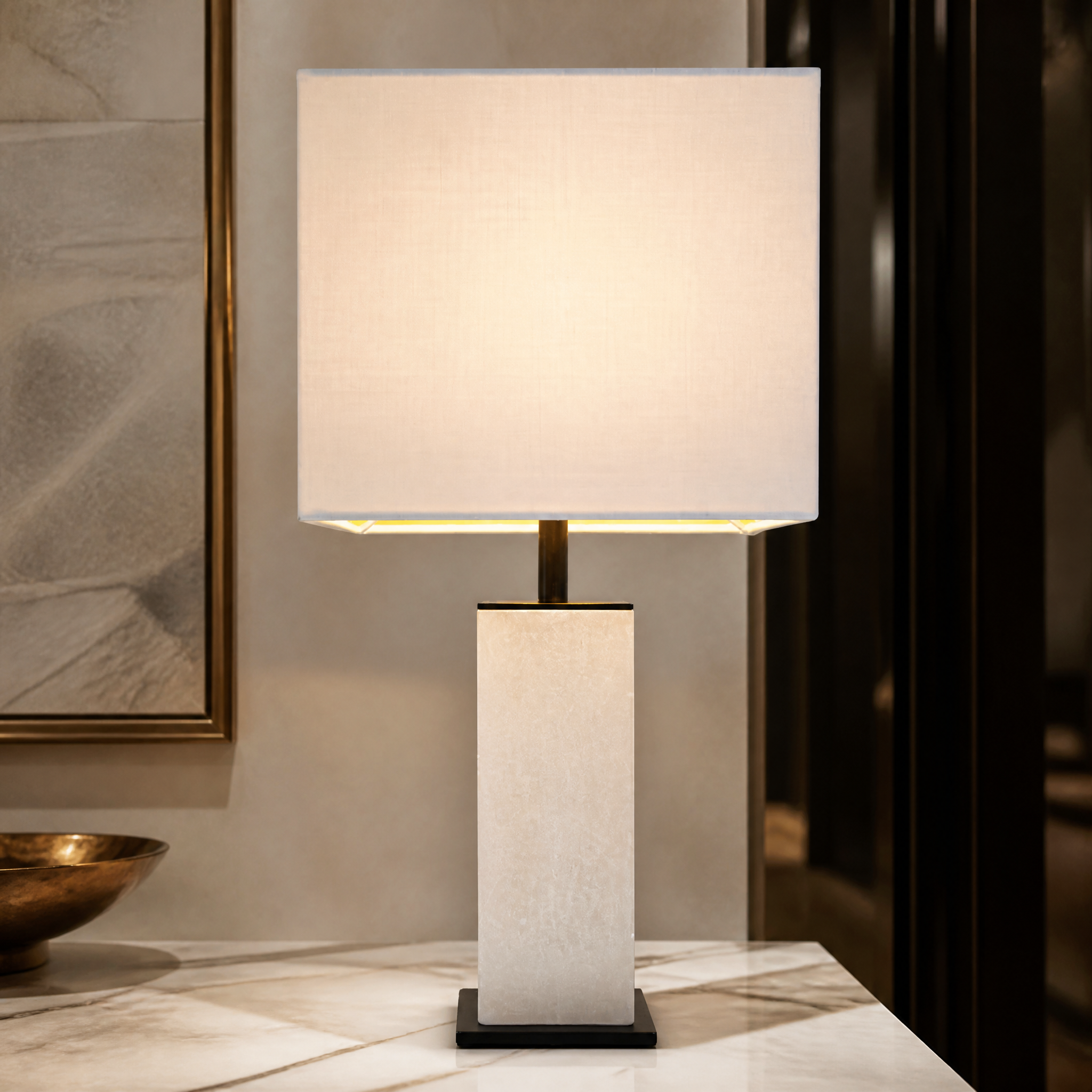 Macro close-up shot of the VORELLI Arlena table lamp showcasing the natural texture of the sculpted square alabaster base and dark bronze detailing.
