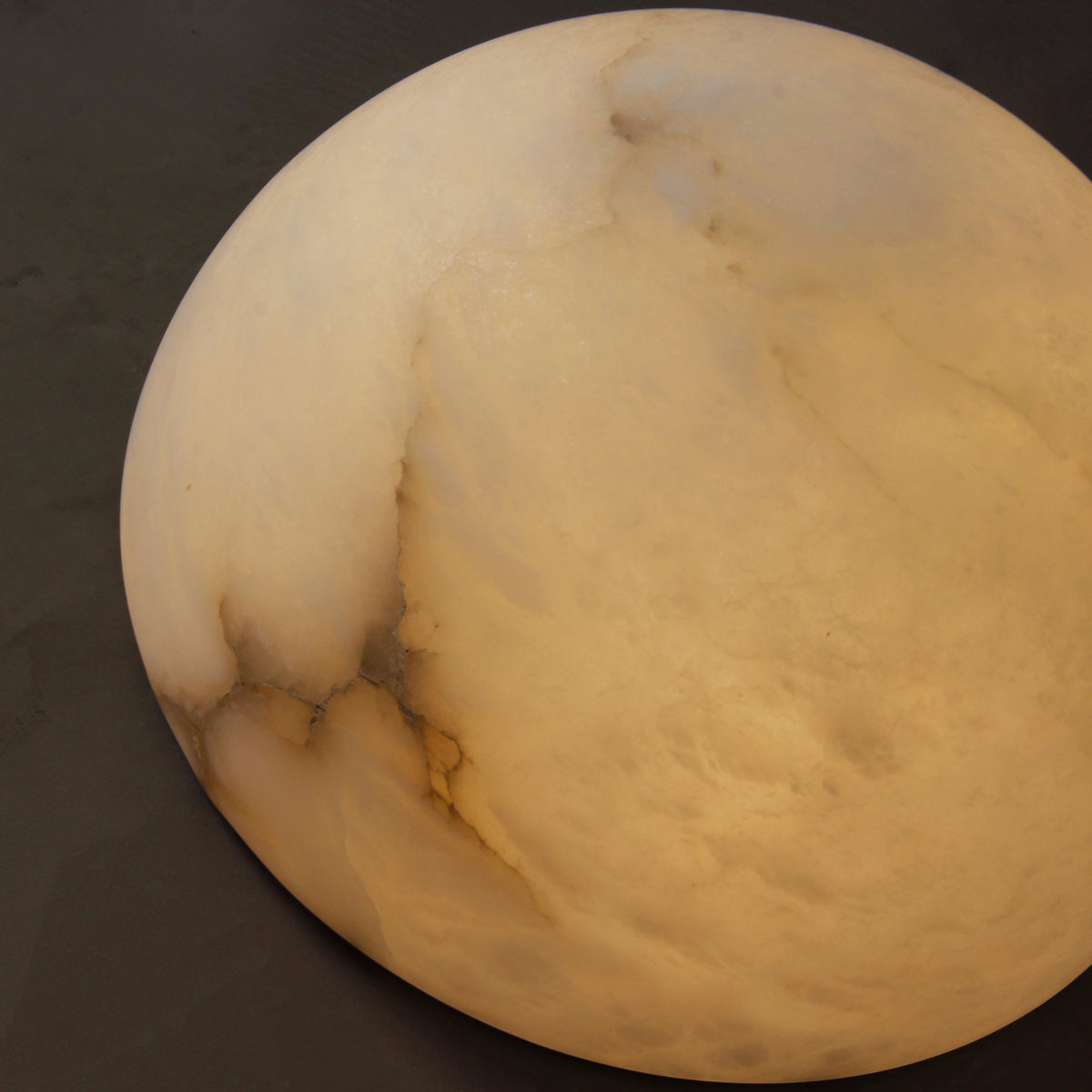 Detailed view of Arona Wall Light showcasing the natural veining and layered marble texture.