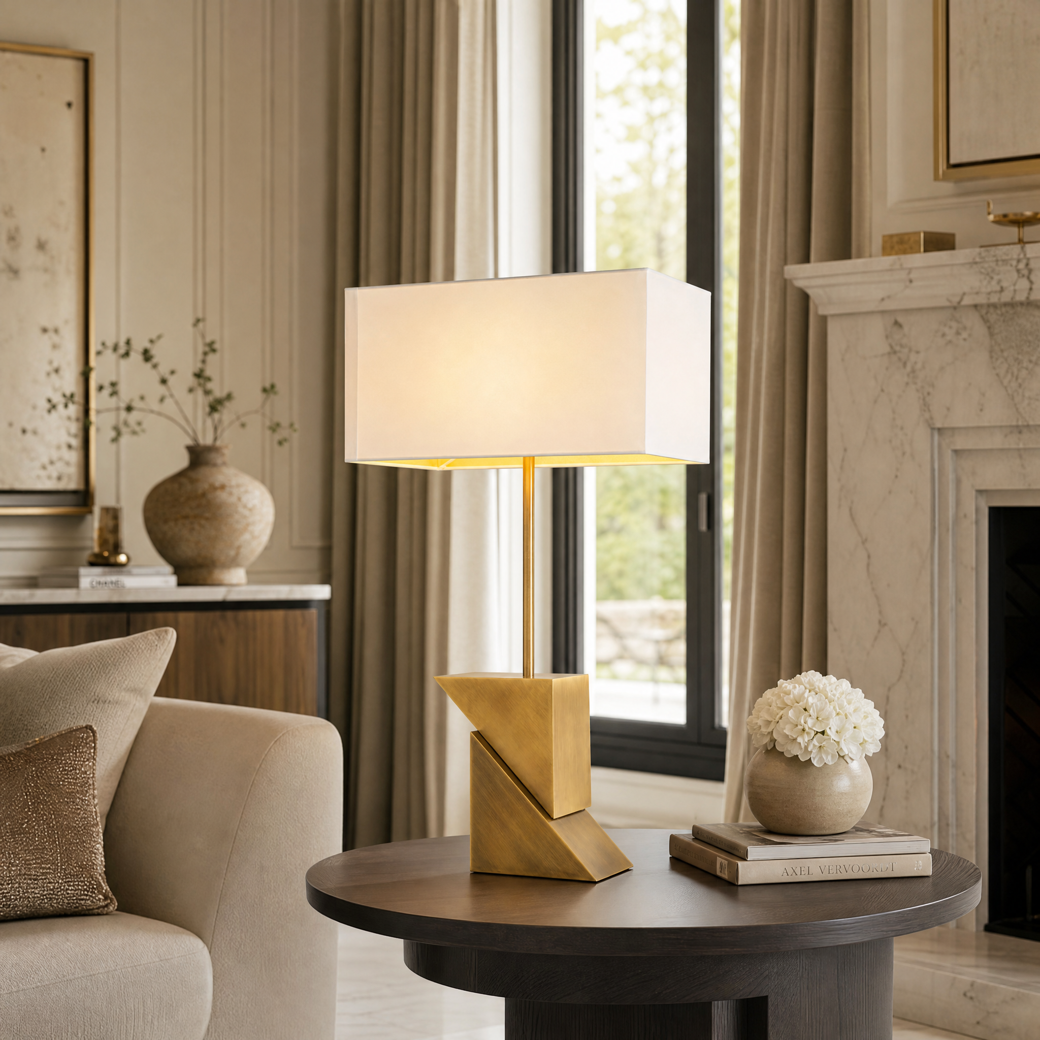 The Arvanta brass table lamp with an off-white shade styled on a contemporary living room console table.