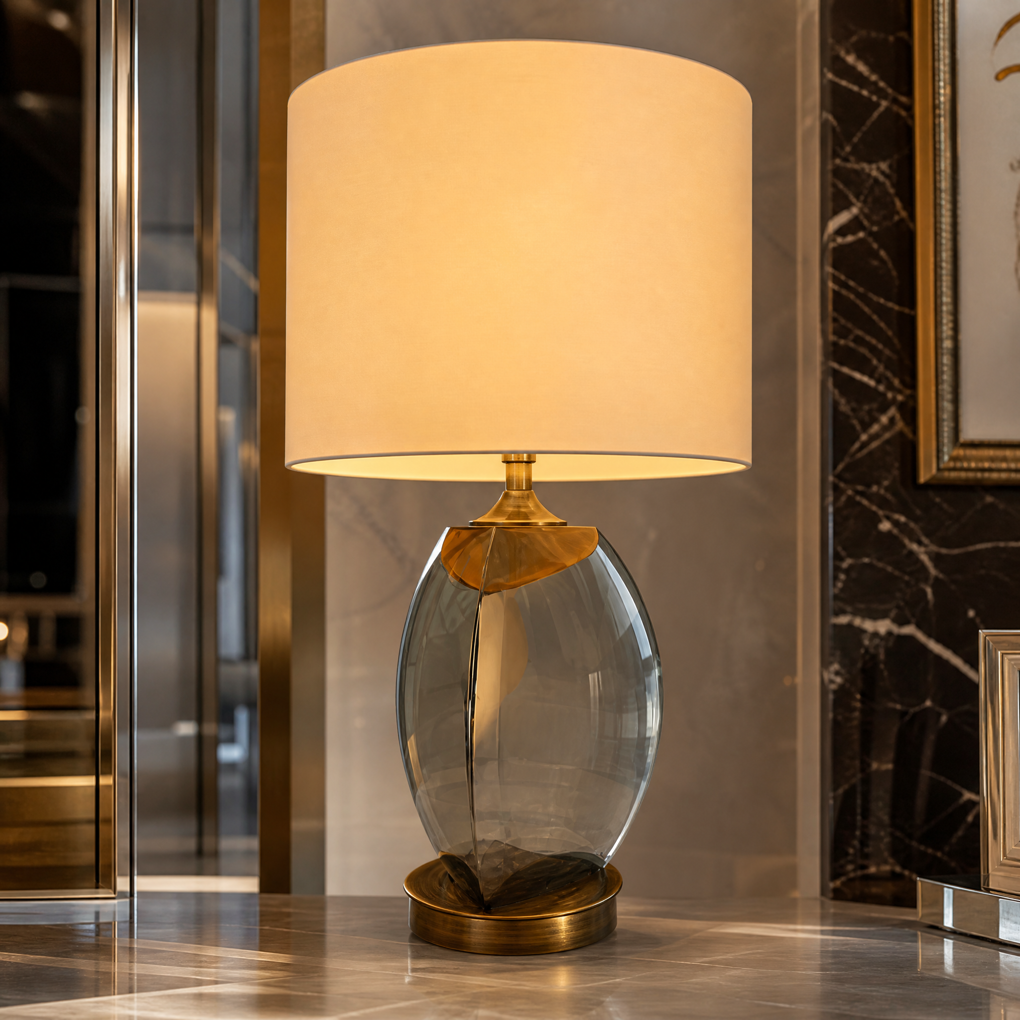 Close up of the Arvessa table lamp highlighting the reflective smoke glass texture and refined antique brass metal detailing.