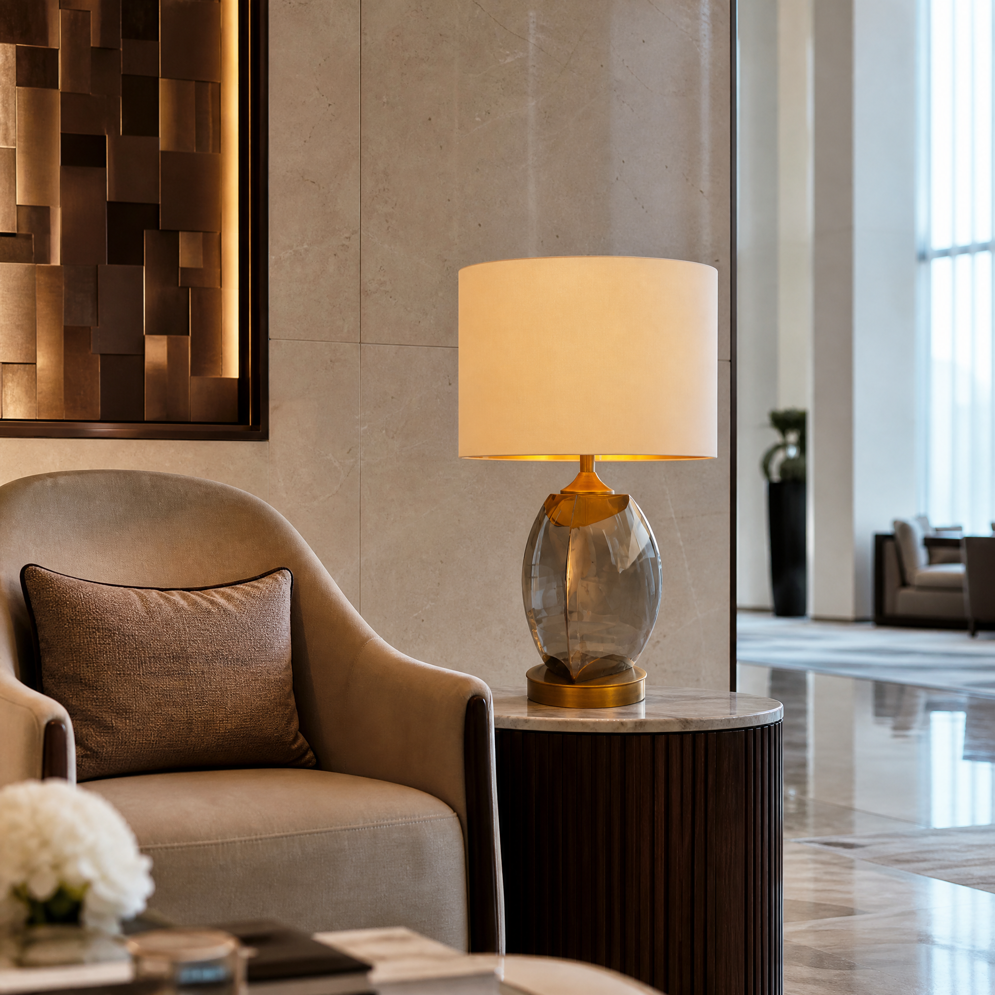 Elegant Arvessa smoke glass lamp with opal shade providing warm ambient lighting on a luxury hotel bedside table.