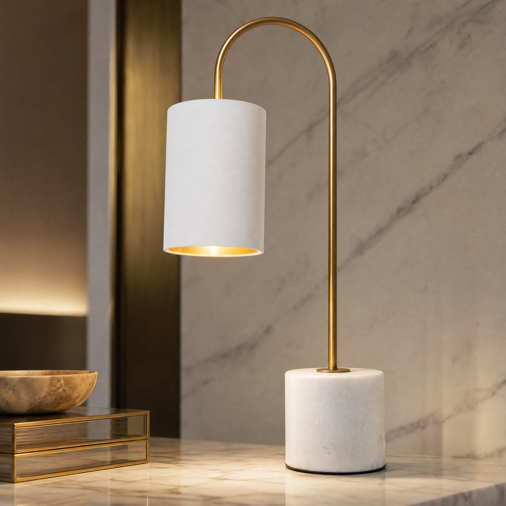 Close-up detail of the VORELLI Arvienne table lamp, highlighting the curved antique brass stem and solid white marble base.