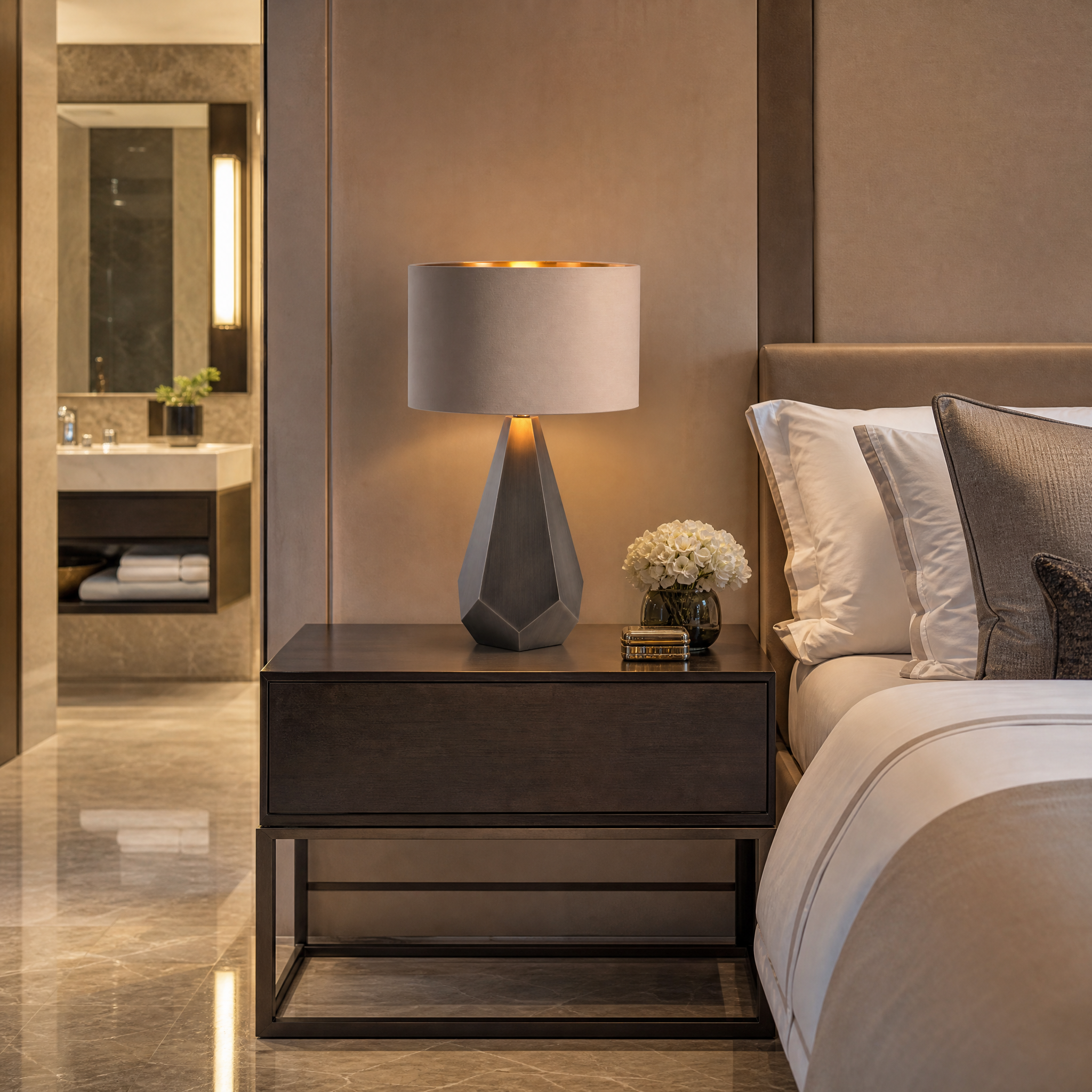 An Arvion contemporary table lamp illuminating a high-end boutique hotel lounge, showcasing its warm gold lining and rich ambient glow.