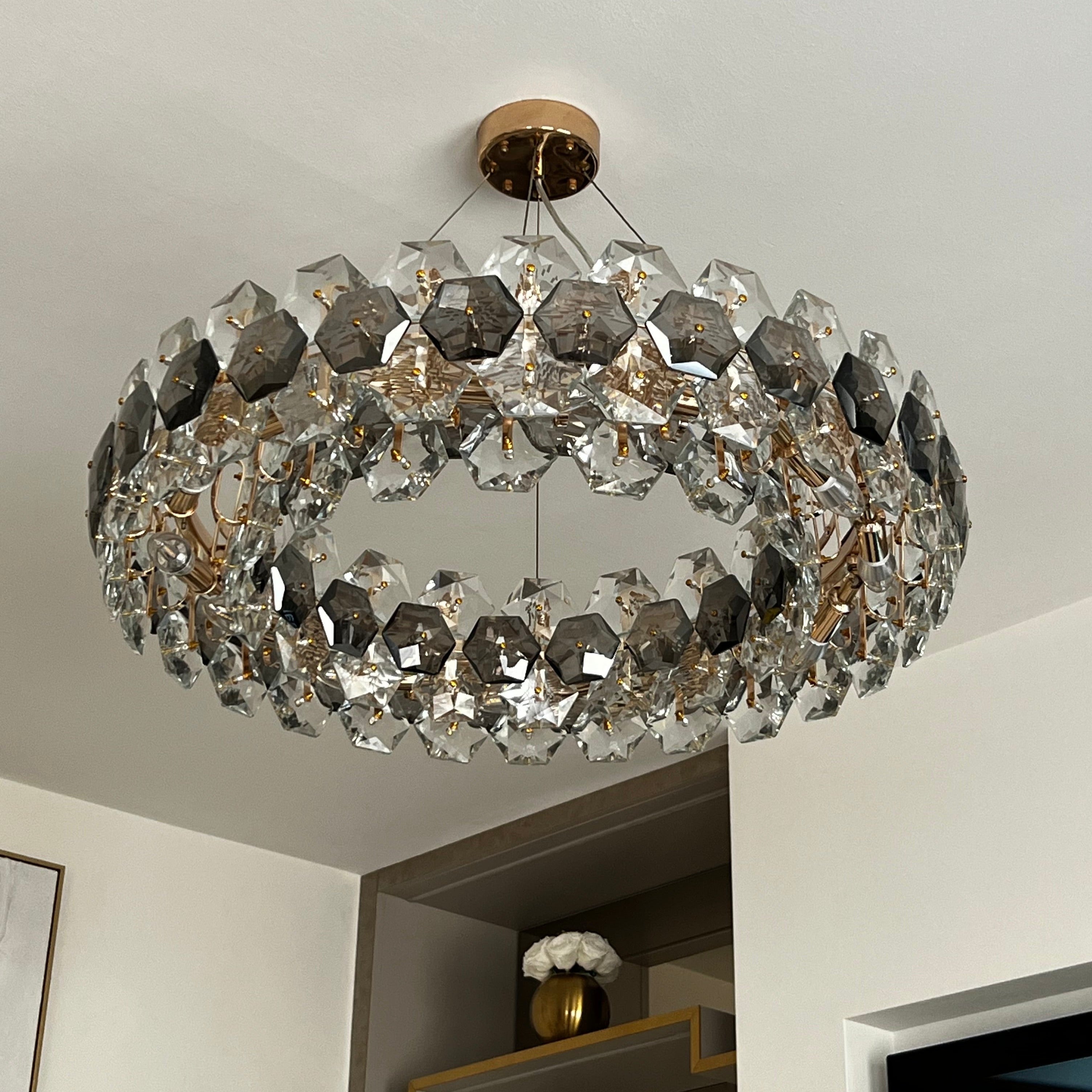 View of the Astoria chandelier fully lit, radiating a soft ambient glow.