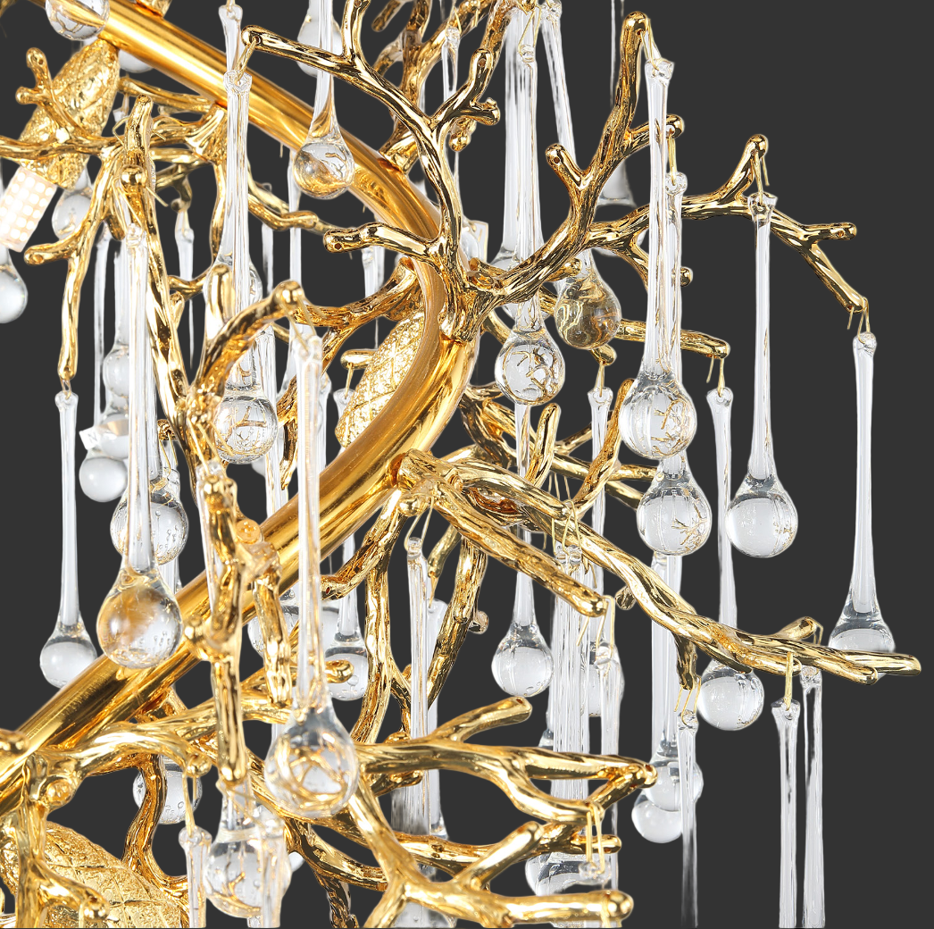 Atmospheric evening shot of the L’Albero d’Oro chandelier casting warm ambient light across a contemporary staircase
