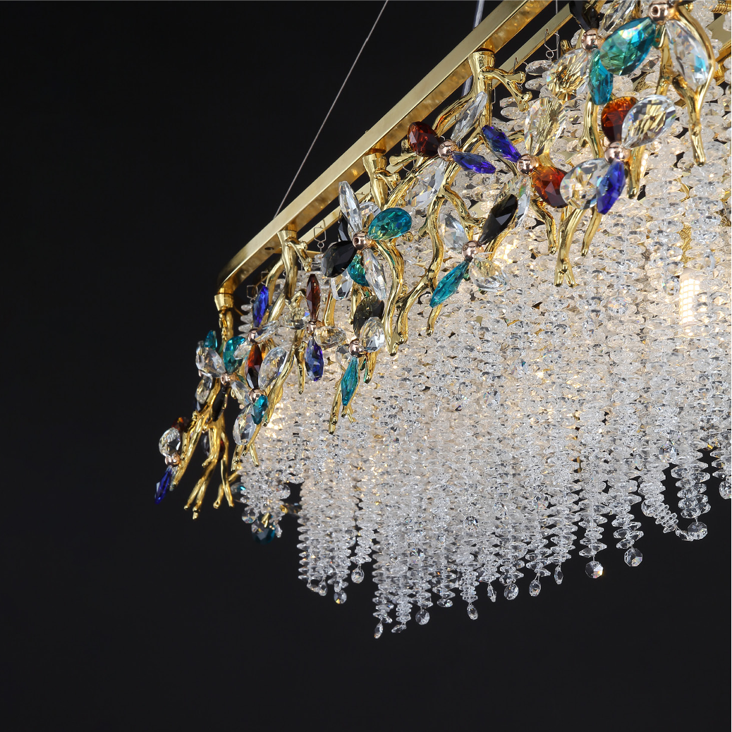 Atmospheric luxury lighting ambiance created by the layered crystal design of the VORELLI Wisteria Rectangular Chandelier III in a statement interior.