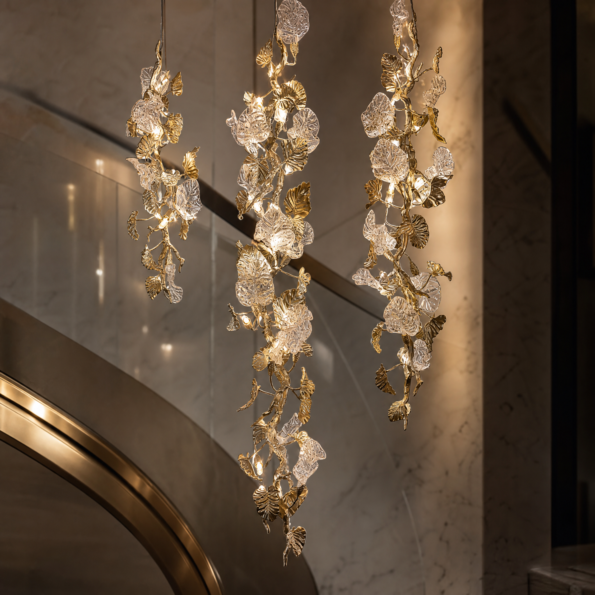 A detailed closeup shot of the artisan-crafted metal branches and delicate hand-blown glass leaves of the Aura Leaf Linear Chandelier.