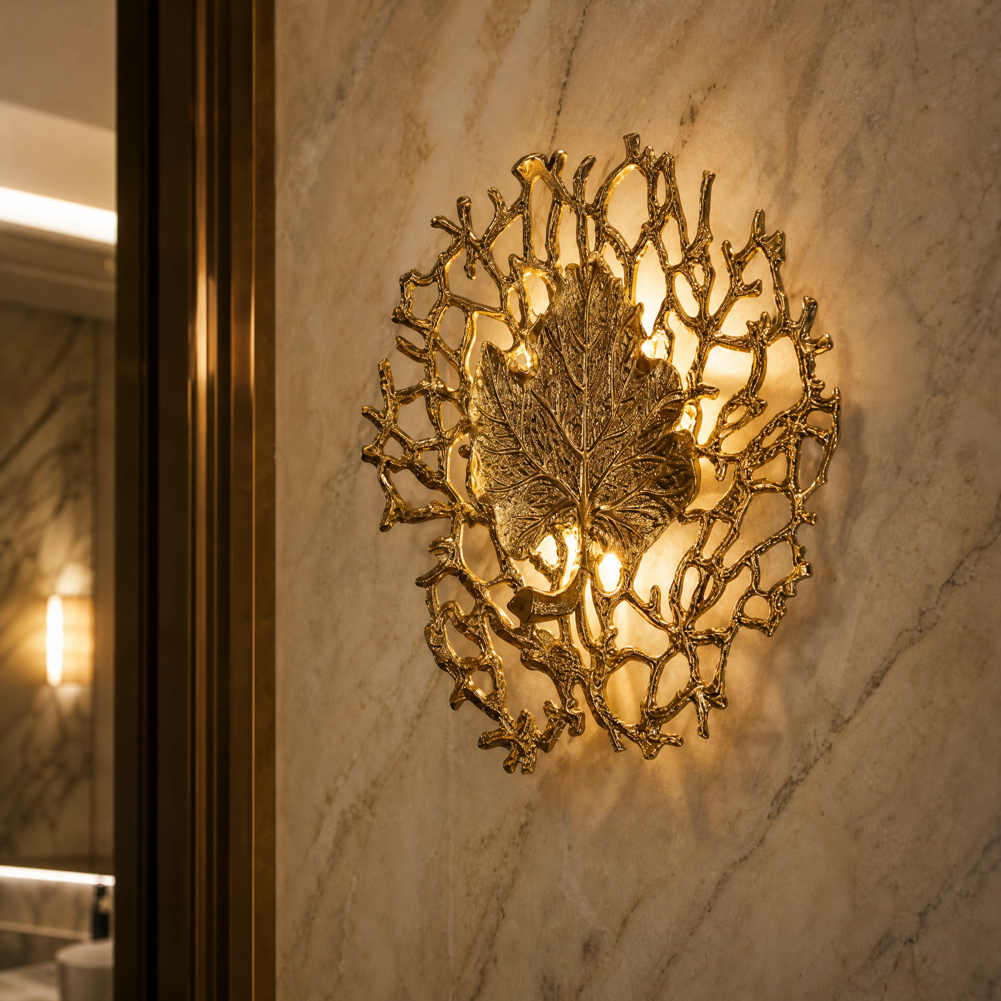 Detailed closeup of the textured sculptural leaf motif and refined organic framework of the VORELLI Aurelia wall light.