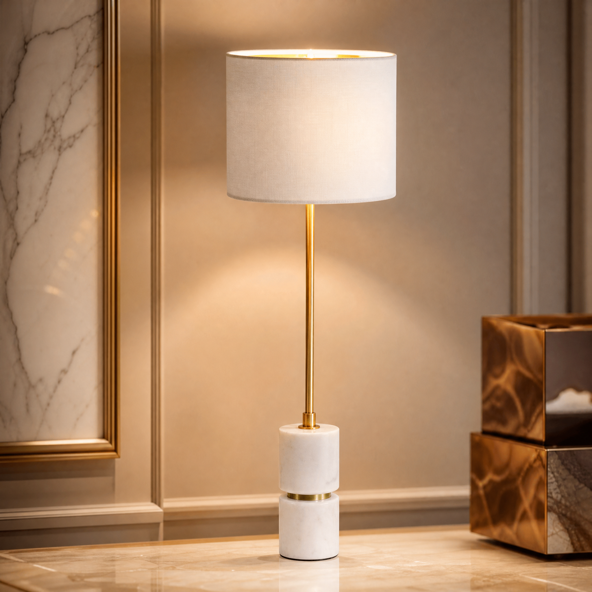 Macro detail shot showing the smooth white marble base and polished antique brass accents of the Aurevia lamp.