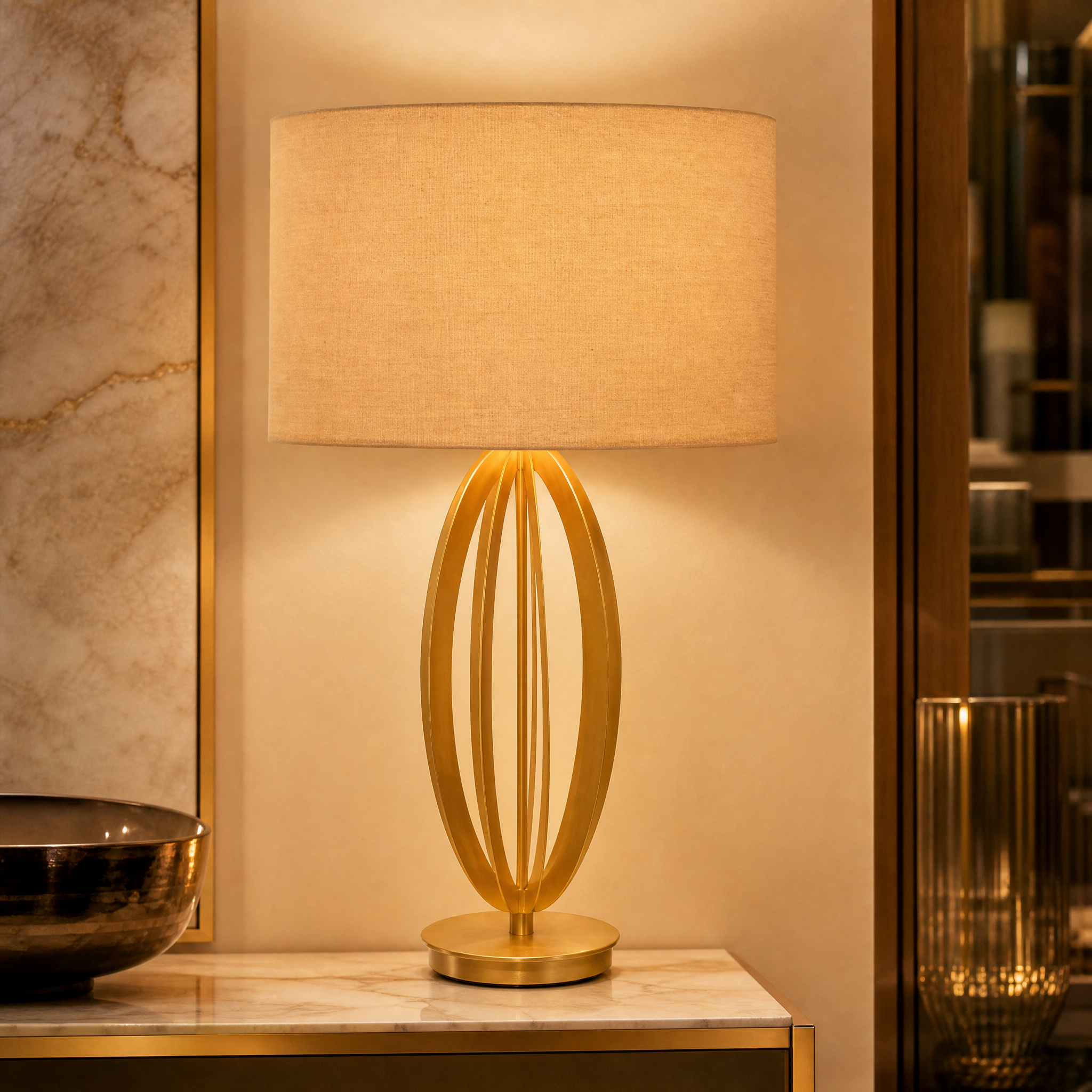 Close up detail of the sculptural pale gold open-frame base of the Aurevon table lamp