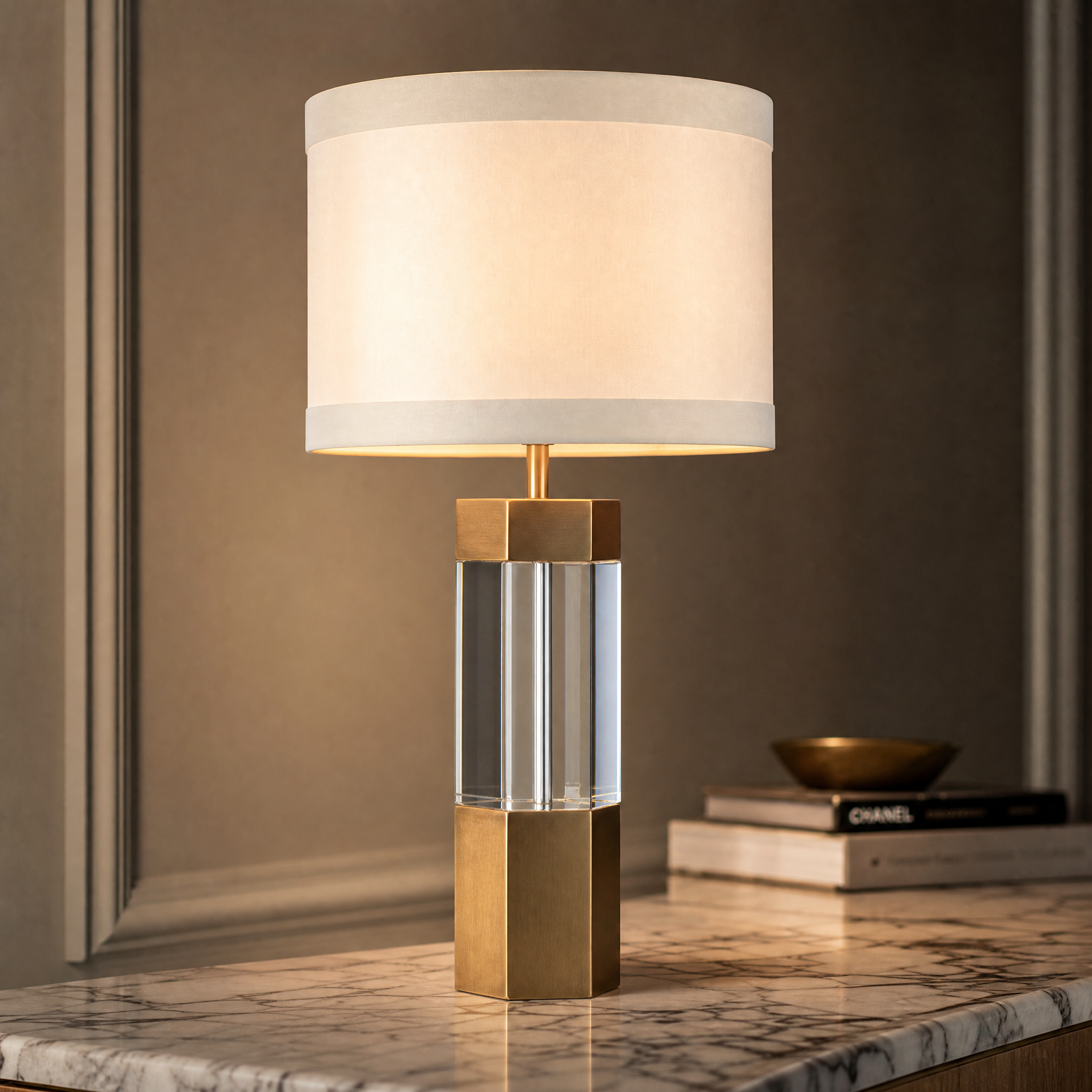 Close-up of the Aurexa table lamp showing refined antique brass finishes and the clear crystal column detail.