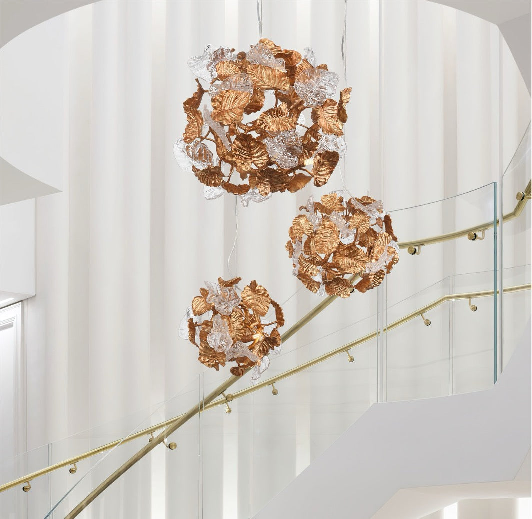Autumn Bloom Pendant lights cascading down a stairwell with sculpted leaf design.