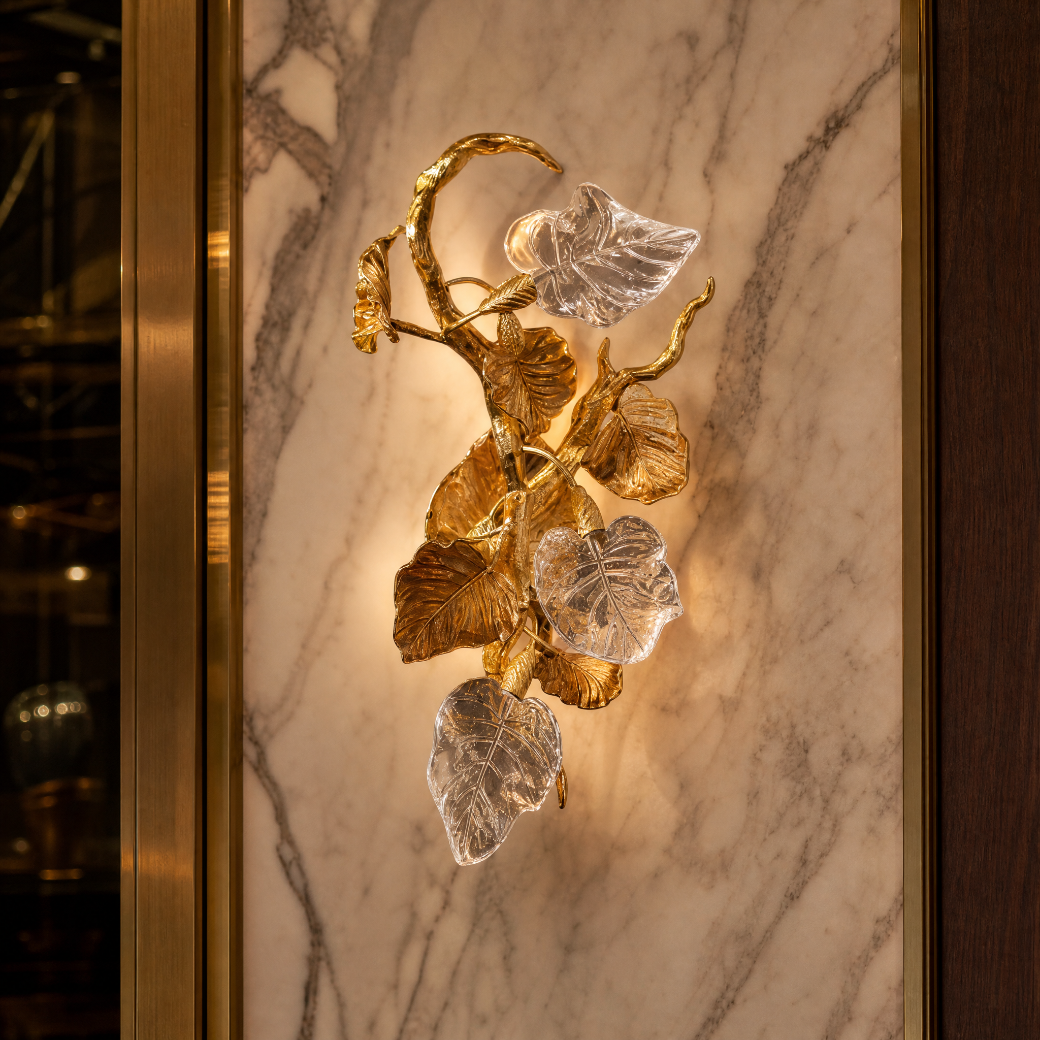 Macro closeup shot of the VORELLI Autumn Bloom wall light, showcasing the intricate texture of the metallic foliage and light refracting through refined crystal details.