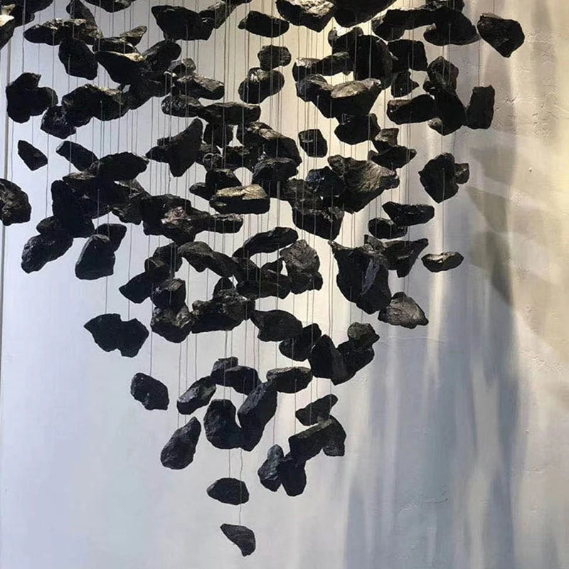 Detailed shot of sculptural pendant elements creating an organic chandelier formation.