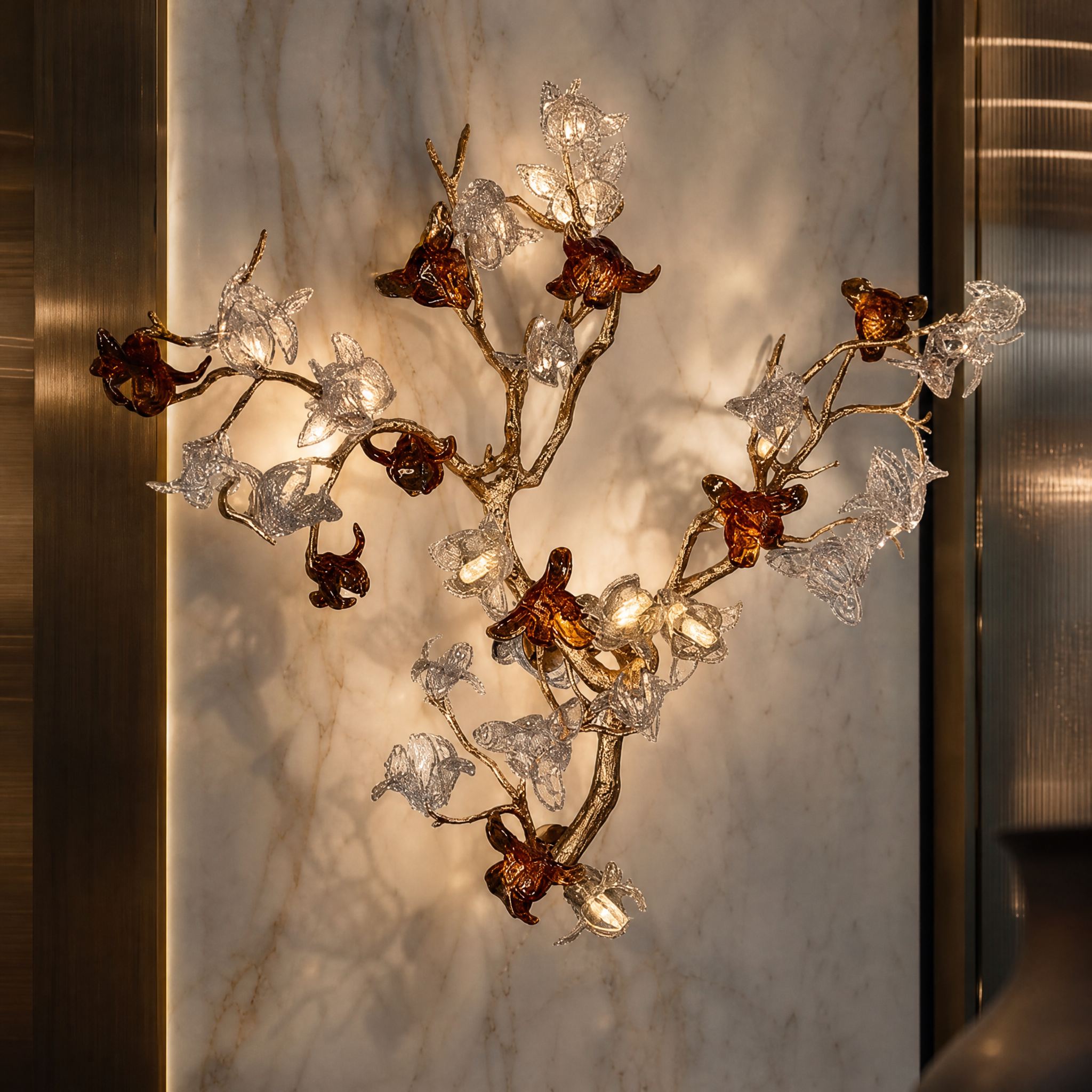 Close up detail of the Bloom Wall Light showing the delicate amber glass highlights and flowing petal craftsmanship.
